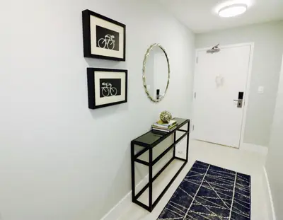 a bathroom with a black console table and a mirror at Coconut Grove 21st Floor Private Studio-Parking & WIFI included in Miami