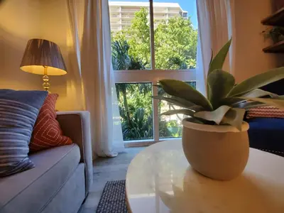 a living room with a potted plant on a coffee table at Cute 1 bedroom unit located in Condo Hotel in the heart of Coconut Grove Free Parking in Miami