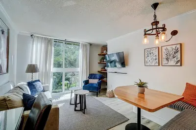 a living room with a couch and a table at Cute 1 bedroom unit located in Condo Hotel in the heart of Coconut Grove Free Parking in Miami