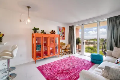 a living room with a pink rug at Coconut Grove Retreat 1 bedroom apartment with Bay views in Miami