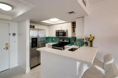 a kitchen with white counters and stainless steel appliances at Coconut Grove Retreat 1 bedroom apartment with Bay views in Miami