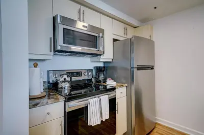 a kitchen with a stainless steel refrigerator and a microwave at Coconut Grove 1 bedroom condo parking included in Miami