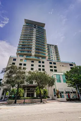 a tall building with trees in front of it at Coconut Grove 1 bedroom condo parking included in Miami