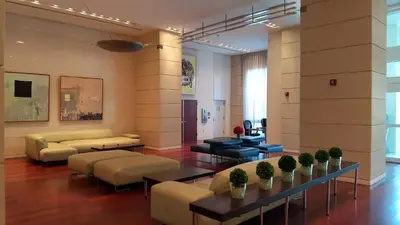 a living room with couches and tables in a building at Private 2 bedroom bay view condo in Coconut Grove includes parking in Miami