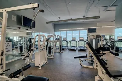 a gym with several treadmills and machines in it at Private 2 bedroom bay view condo in Coconut Grove includes parking in Miami