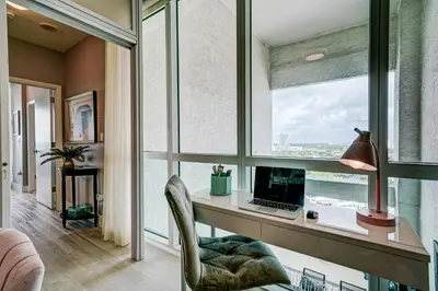 a room with a desk with a computer and a window at Luxury 2-story Penthouse located in Coconut Grove Hotel-includes Parking in Miami