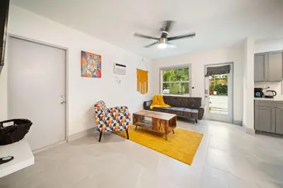 a living room with a couch and a table at Modern Apt Near Las Olas Beach in Fort Lauderdale