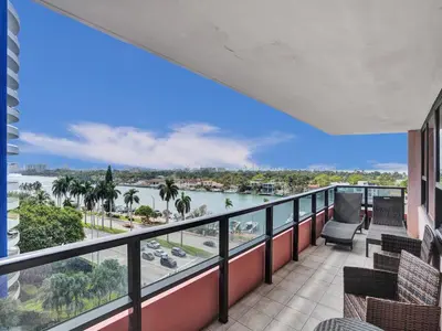 a balcony with chairs and a view of a river at Beach Resort condo 921 in Miami Beach