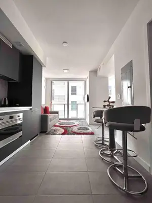 a kitchen with a table and chairs in a room at Modern Studio Downtown with Pool and Gym in Miami