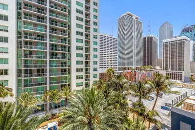 a city skyline with palm trees and tall buildings at Downtown Luxury Studio Pool and Gym in Miami