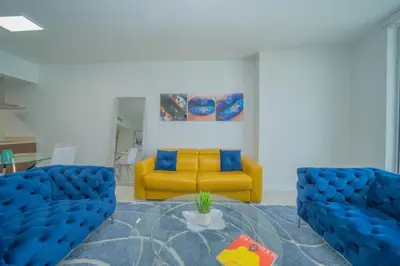 a living room with a yellow couch and a table at Deluxe Suite King 1 Bedroom Icon in Miami
