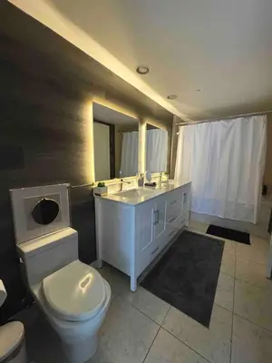 a bathroom with a white toilet and a sink at Deluxe Suite King 1 Bedroom Icon in Miami