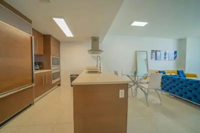 a kitchen with a counter and a table and chairs at Deluxe Suite King 1 Bedroom Icon in Miami