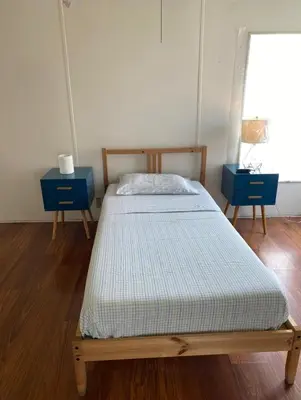 a bed in a room with two blue tables at 1233 Apartment 3 Miami in Tamiami