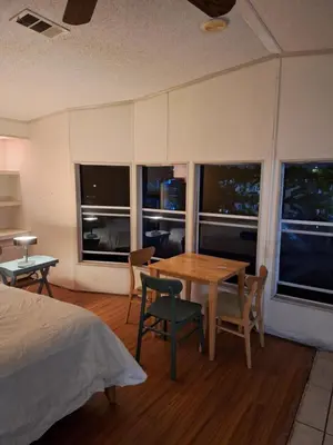 a bedroom with a table and chairs and windows at 1233 Apartment 4 Miami in Tamiami