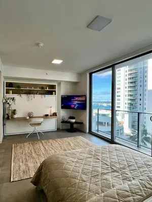 a bedroom with a large bed and a large window at Upscale Ocean View Studio Pool and Gym in Miami