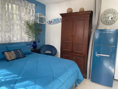 a bedroom with a blue bed and a blue refrigerator at Tropical Classic Retro Florida, Private 2 bedroom Suite with Best Location in Fort Lauderdale