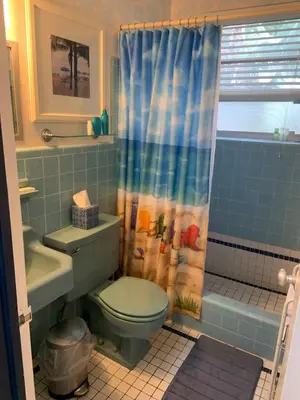 a bathroom with a toilet and a shower curtain at Tropical Classic Retro Florida, Private 2 bedroom Suite with Best Location in Fort Lauderdale