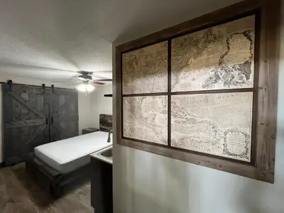 a room with a bed and a map on the wall at cozy studio apartment with private entrance and patio in Miami