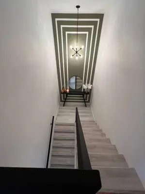 a hallway with a staircase with a chandelier at Super stylish 4 BR Home Steps from the Fun in Fort Lauderdale