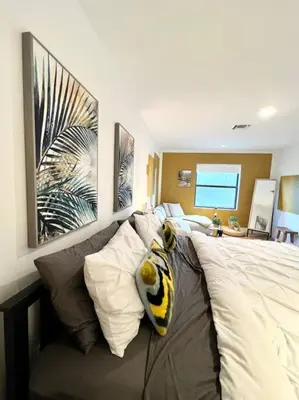 a bedroom with a couch with a stuffed animal on it at Super stylish 4 BR Home Steps from the Fun in Fort Lauderdale