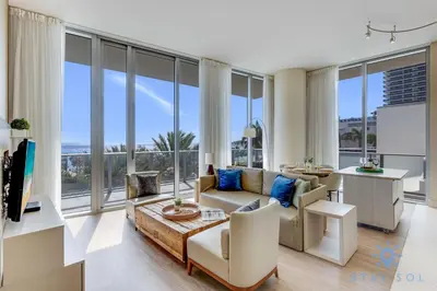 a living room with a couch and a table at Spectacular ocean and beach view in Hollywood