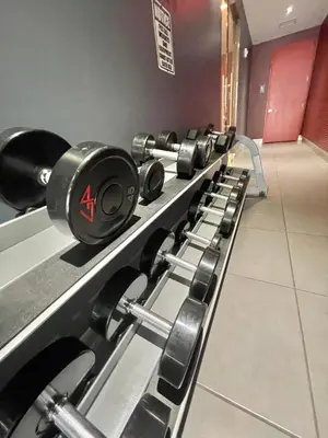 a row of dumbbells lined up in a gym at Beachwalk Studio (Beach, Pool and Gym) in Hallandale Beach