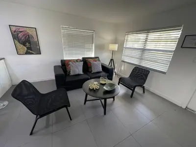 a living room with a couch and chairs and a table at Stylish Pool Home in Hollywood