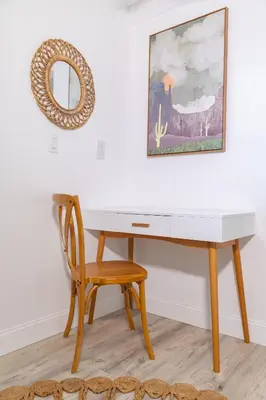 a desk with a chair and a mirror on a wall at Private Villa with Pool and Sauna in Dania Beach