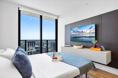 a living room with a bed and a tv at Downtown by Miami Vacation Rentals in Miami