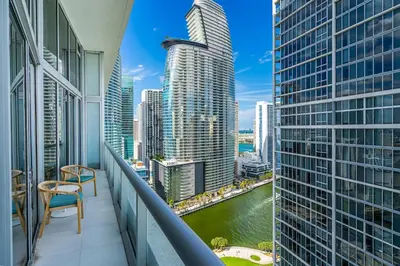 a balcony with a view of a river and skyscrapers at Icon 1 Bed With Water Views 16 ft Ceilings and Free Spa Access in Miami