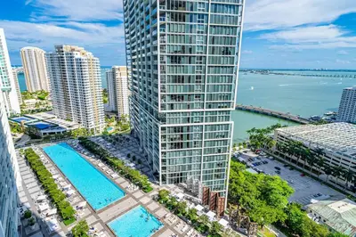 an aerial view of a tall building with a pool at Icon 1 Bed With Water Views 16 ft Ceilings and Free Spa Access in Miami