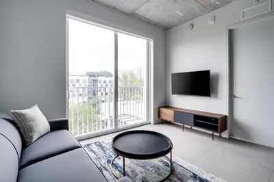 a living room with a couch and a flat screen tv at Kasa Wynwood Miami in Miami