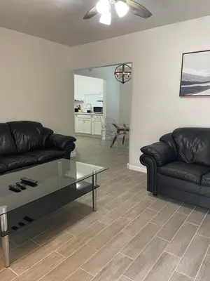 a living room with a couch and a coffee table at City First Story Apartments & Cottage in Fort Lauderdale