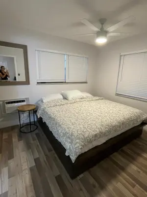 a bedroom with a bed and a ceiling fan at City First Story Apartments & Cottage in Fort Lauderdale