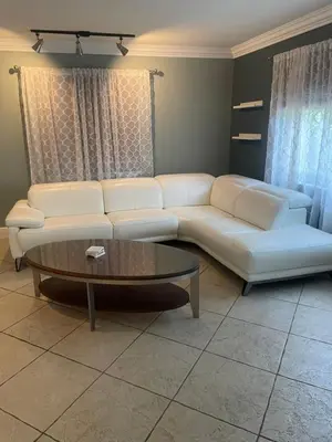 a living room with a white couch and a coffee table at Fort Lauderdale Party house! in Fort Lauderdale