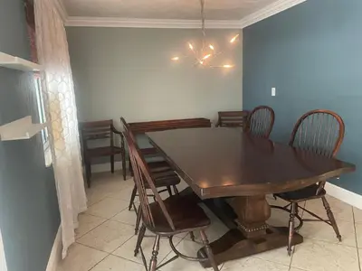 a dining room with a wooden table and chairs at Fort Lauderdale Party house! in Fort Lauderdale