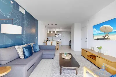 a living room with a couch and a table at South Beach Retreat Balcony Resort Amenities in Hallandale Beach