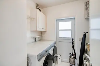 a kitchen with a sink and a washing machine at Marble House in Lauderdale Harbours in Fort Lauderdale