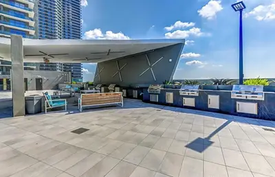 a patio with a table and benches on a building at Downtown Miami 2Br 2Bath Oasis Bayside & Port of Miami Minutes Away in Miami