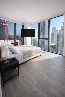 a bedroom with a bed and a large window at Downtown Miami 2Br 2Bath Oasis Bayside & Port of Miami Minutes Away in Miami