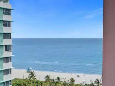 a view of the beach from the balcony of a building at Gorgeous Miami Beach Condo 1614 in Miami Beach