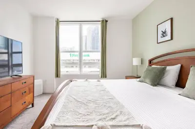 a bedroom with a large bed and a large window at Brickell High Rise Living at its best! w/ Pool Gym in Miami