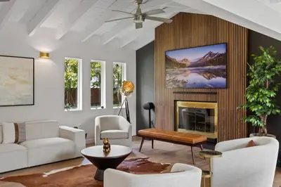 a living room with a couch and a fireplace at Villa Santa Maria in Cutler Bay