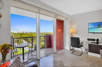 a living room with a balcony with sliding glass doors at Modern Bay View Balcony In The Grove Free Parking in Miami