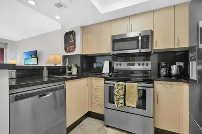 a kitchen with stainless steel appliances and a microwave at Modern Bay View Balcony In The Grove Free Parking in Miami