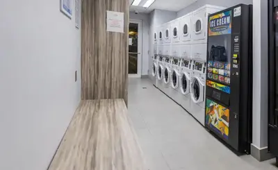 a laundry room with a washer and dryer in a store at Luxe 1 BDR • 32th Floor • Brickell • Ocean Views in Miami