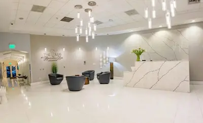 a lobby with chairs and a counter in a building at Luxe 1 BDR • 32th Floor • Brickell • Ocean Views in Miami