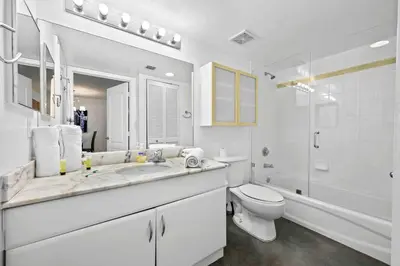 a white bathroom with a toilet and a sink at Luxury 1 BDR • 30th Floor • Brickell • Water Views in Miami