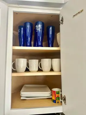 a cabinet filled with blue and white cups and saucers at Lugar encantador balcón vista al agua in North Miami Beach